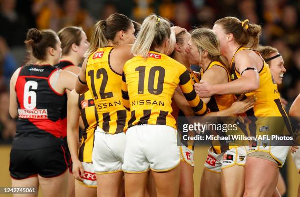 Sophie Locke of the Hawks celebrates the Hawks first goal with teammates during the 2022 S7 AFLW Round 01 match between the Essendon Bombers and the...