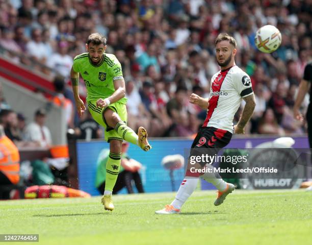 Bruno Fernandes of Manchester United crosses the ball watched by Adam Armstrong of Southampton during the Premier League match between Southampton FC...