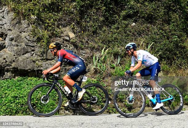 Team Ineos' Ecuadorian rider Richard Carapaz and Team Movistar's Spanish rider Alejandro Valverde ride in Bargana, parish of Tolivia, during the 8th...