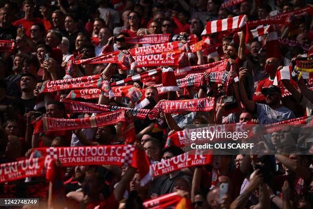 Liverpool fans hold up scarves in the crowd ahead of the English Premier League football match between Liverpool and Bournemouth at Anfield in...