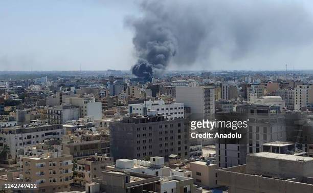 Smoke rises after clashes between two rival militias operating between Qaser Ben Ghashir and Al-Sarim regions, in Tripoli, Libya on August 27, 2022....