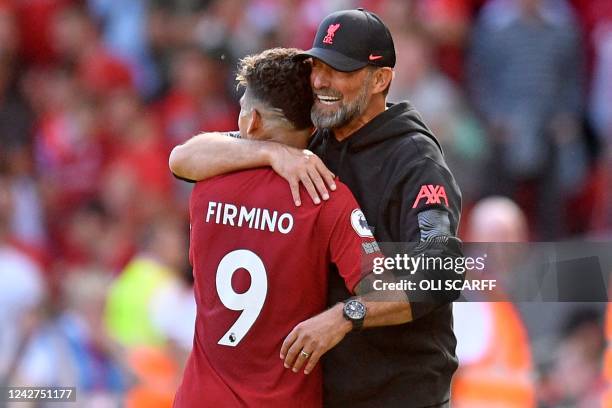 Liverpool's German manager Jurgen Klopp embraces Liverpool's Brazilian striker Roberto Firmino as he is substituted during the English Premier League...