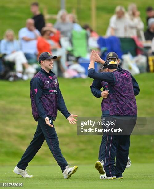 Tyrone , United Kingdom - 27 August 2022; Jack Beattie of CIYMS, left, celebrates catching the wicket of Faiz Fazal of Lisburn during the Clear...