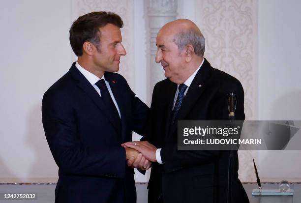 French President Emmanuel Macron and Algeria's President Abdelmadjid Tebboune attend a signing ceremony in the pavilion of honour at Algiers airport,...