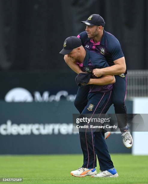 Tyrone , United Kingdom - 27 August 2022; Jason van der Merve of CIYMS is congratulated by Ross Adair, above, after catching the wicket of David...