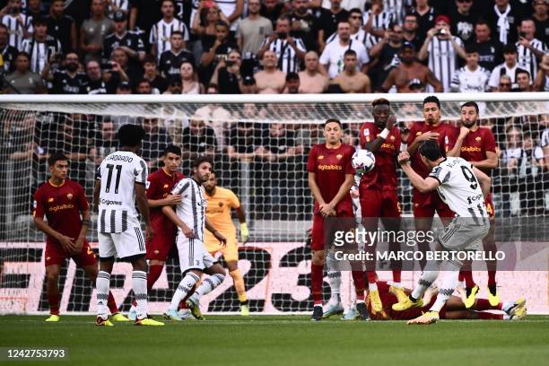 Juventus' Serbian forward Dusan Vlahovic shoots a free kick to open the scoring during the Italian Serie A football match between Juventus and AS...
