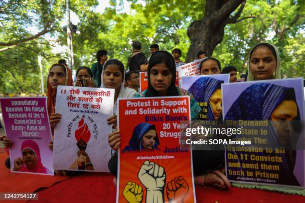 Demonstrators hold placards during a protest against the release of a group of convicts who had gang raped Bilkis Bano during the 2002 communal riots...