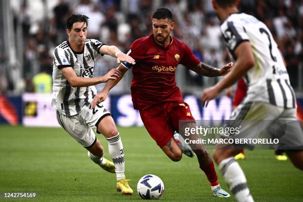 Roma's Italian midfielder Lorenzo Pellegrini challenges Juventus' Italian midfielder Fabio Miretti during the Italian Serie A football match between...