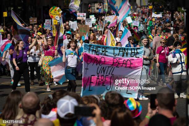 The LGBTQIA+ community hold a banner and placards during the Pride Parade. This year sees the parade back at full capacity for the first time since...