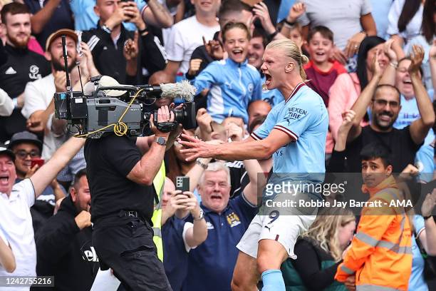Erling Haaland of Manchester City celebrates with a TV cameraman after scoring a goal to make it 4-2 during the Premier League match between...