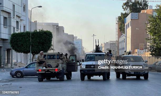 Fighters loyal to the Government of National Unity are pictured in a street in the Libyan capital Tripoli on August 27 following clashes between...