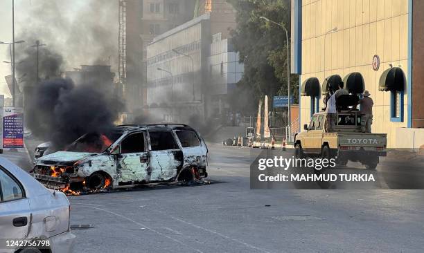 Fighters loyal to the Government of National Unity are pictured in a street in the Libyan capital Tripoli on August 27 following clashes between...