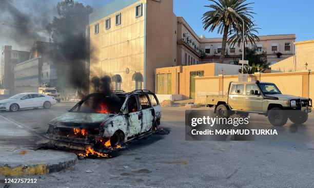 Fighters loyal to the Government of National Unity are pictured in a street in the Libyan capital Tripoli on August 27 following clashes between...