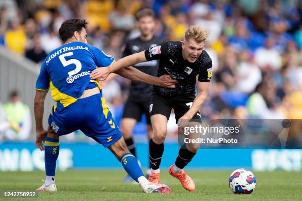 Ben Whitfield of Barrow and Will Nightingale of AFC Wimbledon battle for the ball during the Sky Bet League 2 match between AFC Wimbledon and Barrow...