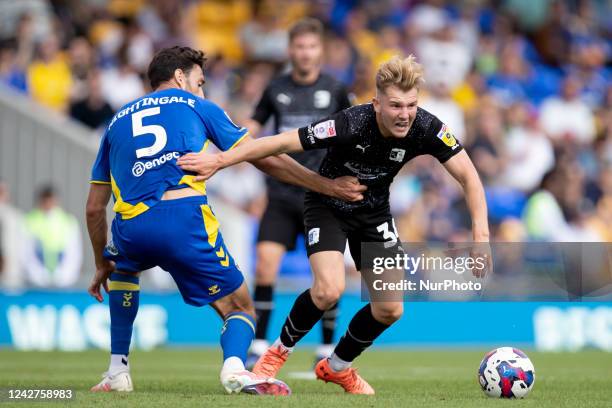 Ben Whitfield of Barrow and Will Nightingale of AFC Wimbledon battle for the ball during the Sky Bet League 2 match between AFC Wimbledon and Barrow...