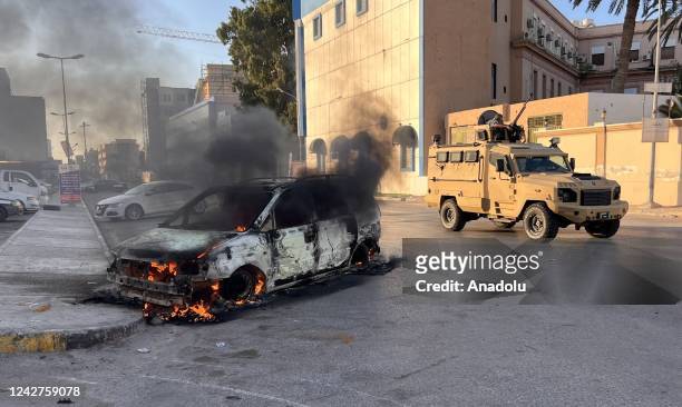 Wrecked vehicle burns at the Republic Street as clashes between rival militias spread to several neighborhoods in the Libyan capital Tripoli on...