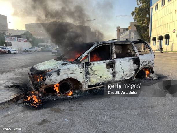 Wrecked vehicle burns at the Republic Street as clashes between rival militias spread to several neighborhoods in the Libyan capital Tripoli on...