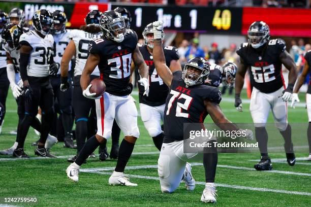 Qadree Ollison of the Atlanta Falcons celebrates a touchdown with Leroy Watson during the first half of the preseason game against the Jacksonville...