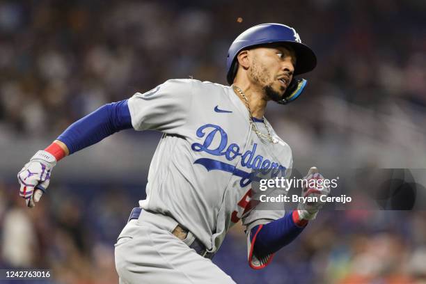 Mookie Betts of the Los Angeles Dodgers rounds the bases after hitting a home run during the third inning against the Miami Marlins at loanDepot park...