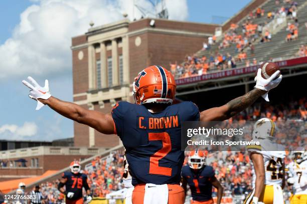 Illinois Fighting Illini running back Chase Brown celebrates after a receiving touchdown during the college football game between the Wyoming Cowboys...