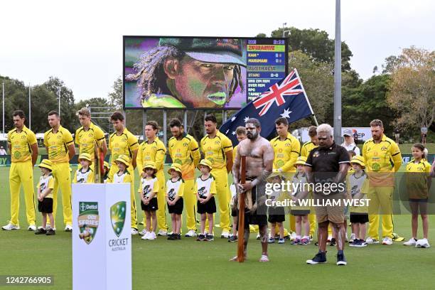 Australian players observe a minute's silence for late Australian cricketer Andrew Symonds before the first one-day international cricket match...