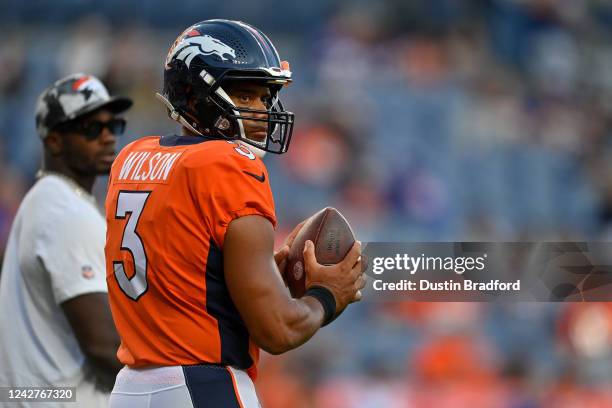 Quarterback Russell Wilson of the Denver Broncos warms up before a preseason game against the Minnesota Vikings at Empower Field at Mile High on...