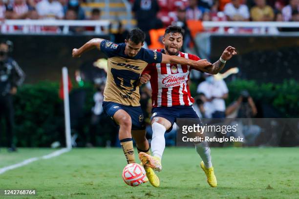 Alexis Vega of Chivas fights for the ball with Pablo Bennevendo of Pumas during the 11th round match between Chivas and Pumas UNAM as part of the...