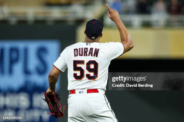 Jhoan Duran of the Minnesota Twins celebrates recording a strikeout against Evan Longoria of the San Francisco Giants to end the top of the tenth...