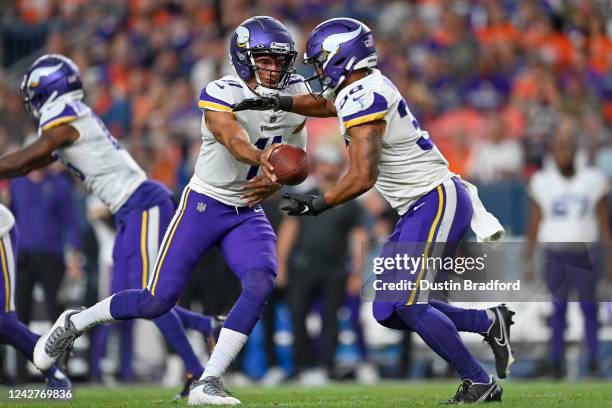 Quarterback Kellen Mond of the Minnesota Vikings hands the ball off to running back Bryant Koback in the fourth quarter of a preseason game against...