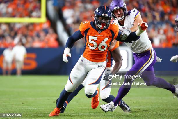 Baron Browning of the Denver Broncos rushes through the Minnesota Vikings offensive line during the first half of a preseason game at Empower Field...