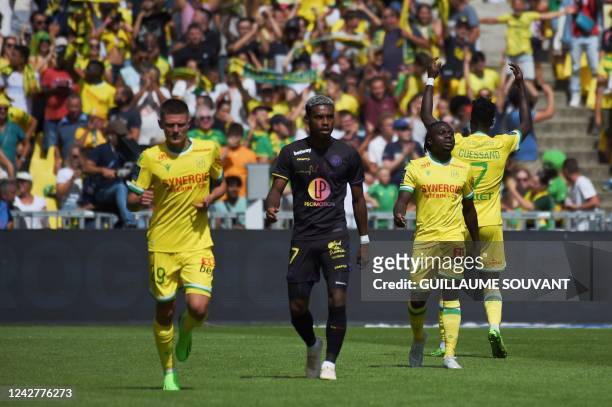 Nantes' Nigerian forward Moses Simon celebrates with teammates after scoring his team's third goal during the French L1 football match between FC...