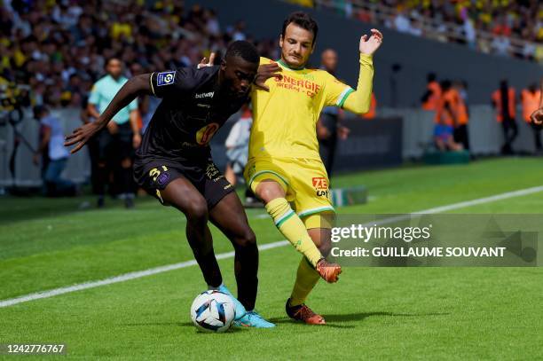 Toulouse's Cameroonian defender Kevin Keben fights for the ball with Nantes' Spanish midfielder Pedro Chirivella during the French L1 football match...