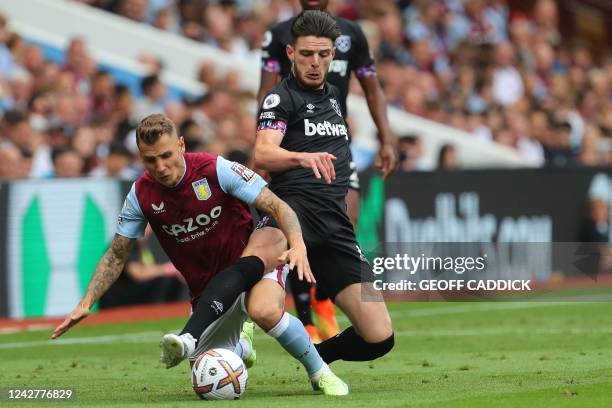 Aston Villa's French defender Lucas Digne vies with West Ham United's English midfielder Declan Rice during the English Premier League football match...