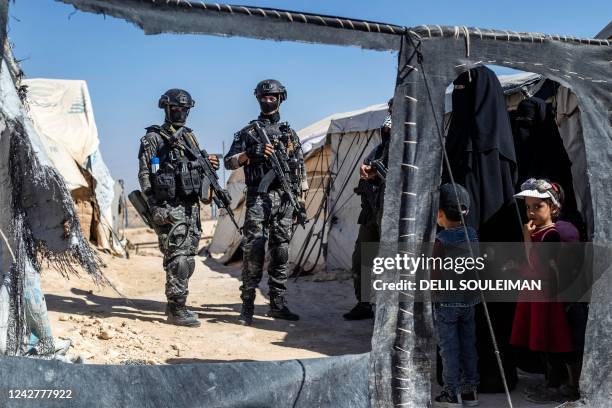 Members of the Syrian Kurdish Asayish security forces inspect tents at the Kurdish-run al-Hol camp, which holds relatives of suspected Islamic State...