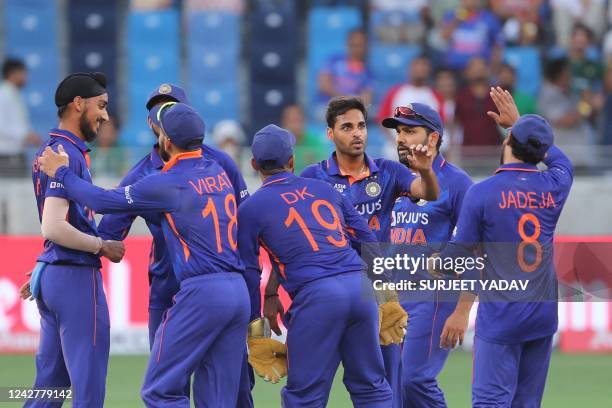 India's Bhuvneshwar Kumar celebrates with teammates after dismissing Pakistan's captain Babar Azam during the Asia Cup Twenty20 international cricket...