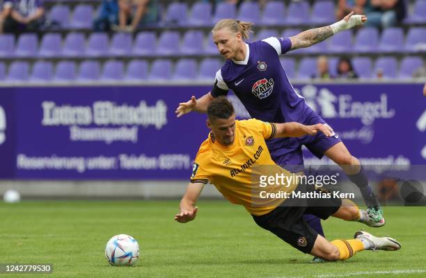 Stefan Kutschke of Dresden challenges for the ball with Marvin Stefaniak of Aue during the 3.Liga match between Erzgebirge Aue and SG Dynamo Dresden...