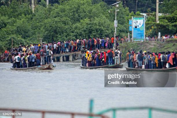 Crowd of climate migrant workers hurries to attend to their office in time after the cross of Poshur river by boat at Mongla city in Bagerhat,...