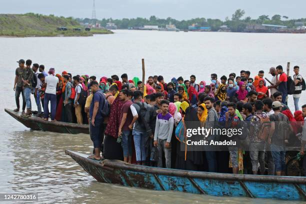 Crowd of climate migrant workers hurries to attend to their office in time after the cross of Poshur river by boat at Mongla city in Bagerhat,...