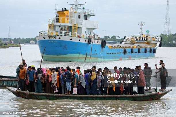 Crowd of climate migrant workers hurries to attend to their office in time after the cross of Poshur river by boat at Mongla city in Bagerhat,...