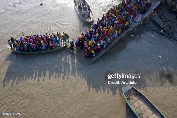 Aerial view of crowd of climate migrant workers hurries cross the Poshur river to attend to their office in time by boat at Mongla city in Bagerhat,...
