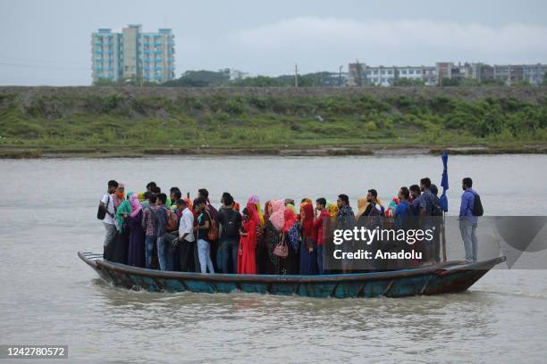 Crowd of climate migrant workers hurries to attend to their office in time after the cross of Poshur river by boat at Mongla city in Bagerhat,...