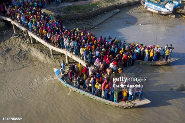 Aerial view of crowd of climate migrant workers hurries cross the Poshur river to attend to their office in time by boat at Mongla city in Bagerhat,...