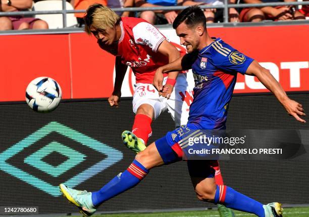 Reims' Japanese forward Junya Ito kicks the ball past Lyon's Argentinian defender Nicolas Tagliafico during the French L1 football match between...