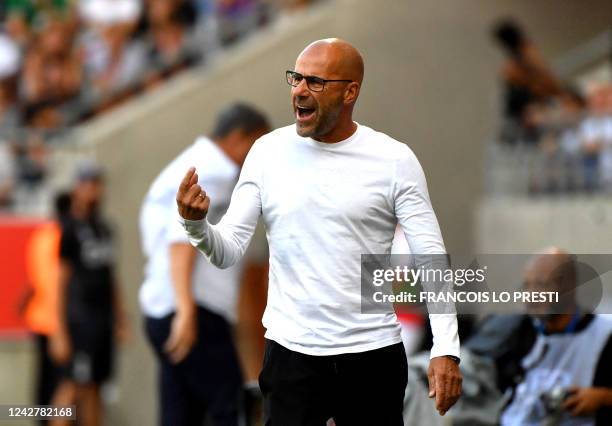 Lyon's head coach Peter Bosz reacts from the sideline during the French L1 football match between Stade de Reims and Olympique Lyonnais at Stade...