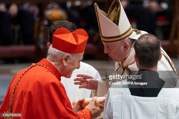New Cardinal Fortunato Frezza receives the red three-cornered biretta hat from Pope Francis during the Consistory to create 20 new cardinals at St....