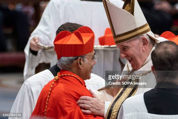 New Cardinal Filipe Neri António Sebastião do Rosário Ferrão receives the red three-cornered biretta hat from Pope Francis during the Consistory to...