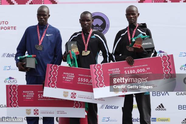 Kenneth Kiplagat Limo, second place, Edwin Kiprop Kiptoo, first place, and Rhonzas Lokitam Kilimo, third place, stand on the podium in the 2022...