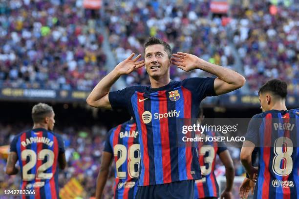 Barcelona's Polish forward Robert Lewandowski celebrates after scoring his team's first goal during the Spanish League football match between FC...