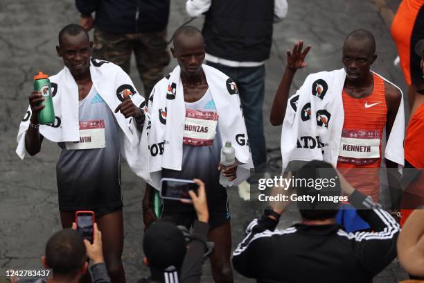 Edwin Kiprop Kiptoo, first place, Rhonzas Lokitam Kilimo, third place, and Kenneth Kiplagat Limo, second place, after crossing the finish line in the...