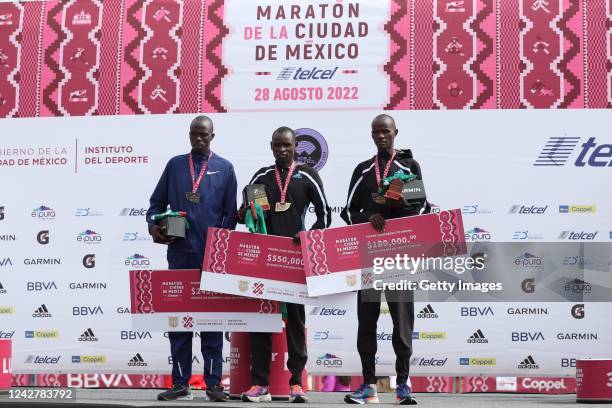 Kenneth Kiplagat Limo, second place, Edwin Kiprop Kiptoo, first place, and Rhonzas Lokitam Kilimo, third place, stand on the podium in the 2022...